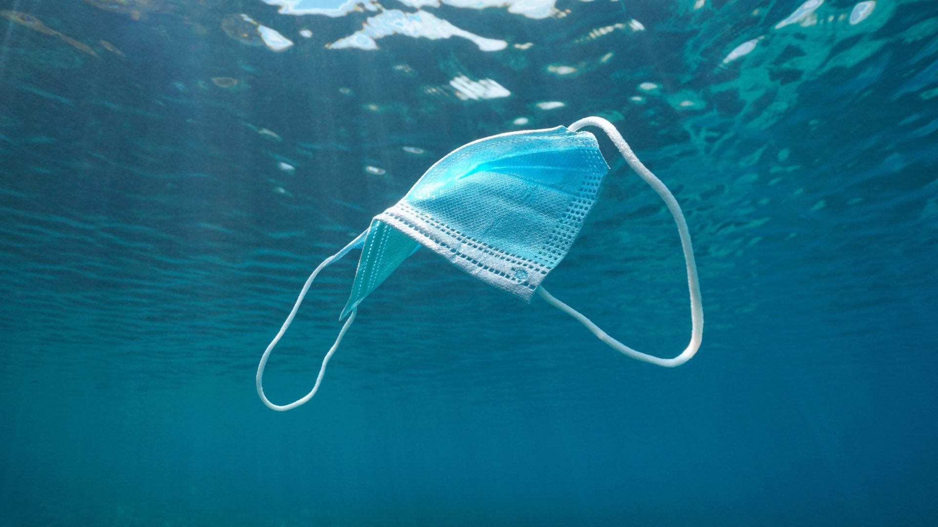 Surgical face mask underwater pollution in ocean