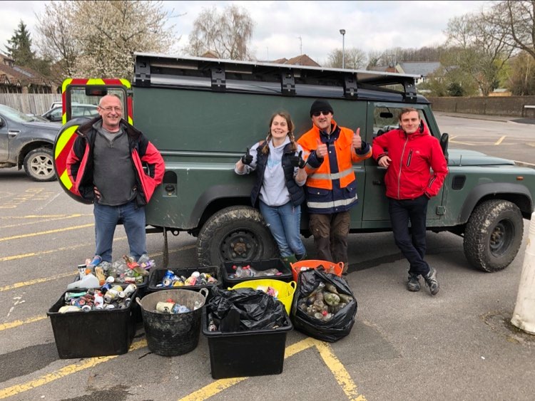 Volunteers with collected plastic in bins