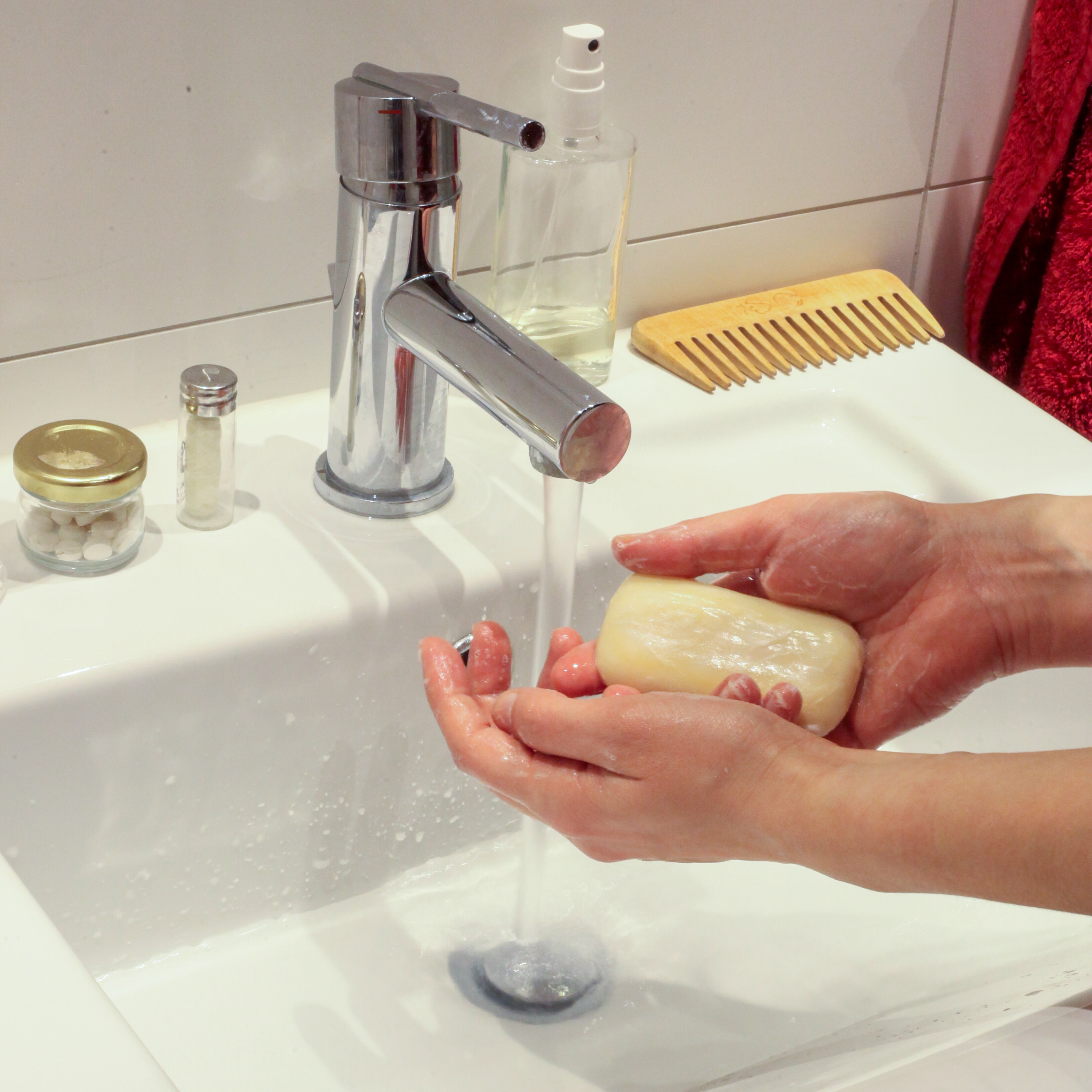 Person washing hands with a bar of soap